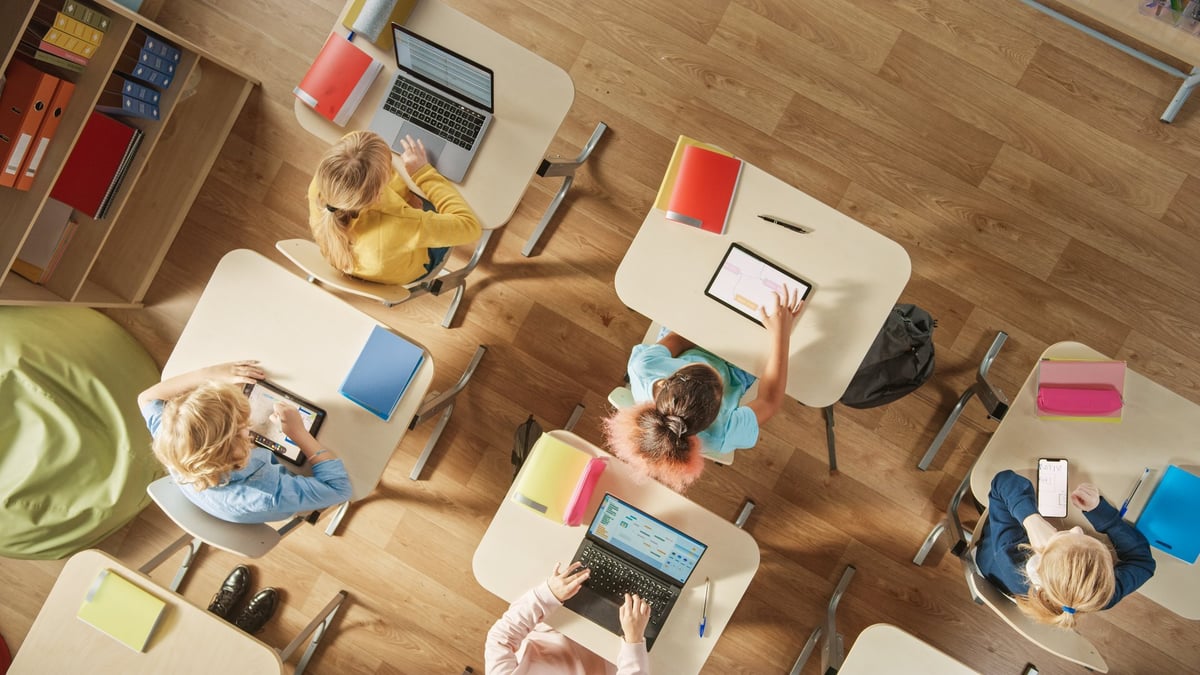 Elementary School Computer Science Classroom: Children using personal computers and digital tablets for assignments
